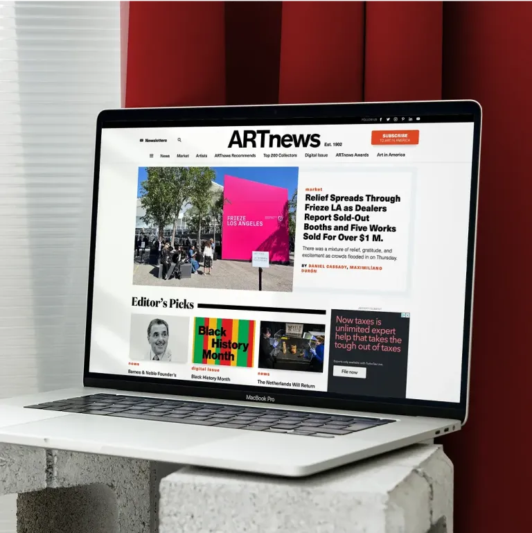Laptop showing the ARTnews homepage with headlines, editor’s picks, and a feature on Frieze LA.