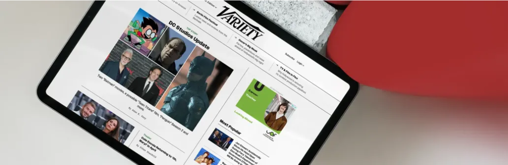 Tablet displaying the Variety website with headlines, celebrity photos, and entertainment news.