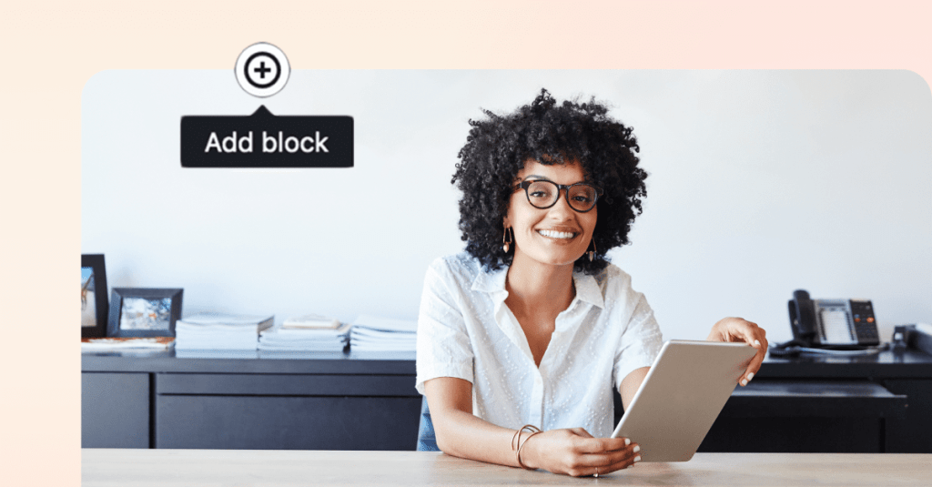 Smiling woman with curly hair holding a tablet, adding content on a digital solution.
