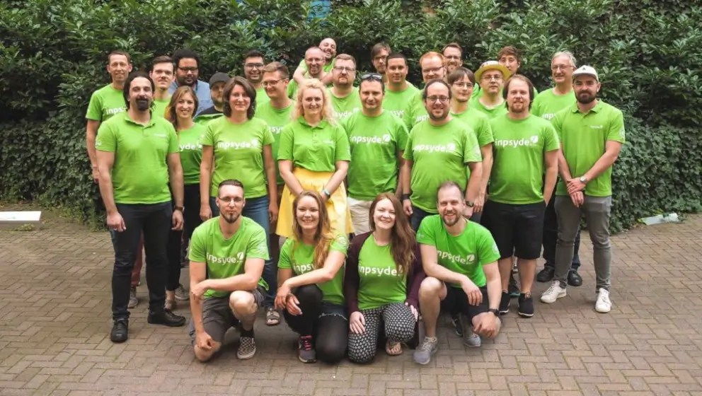 Team smiling together, representing collaboration and content workflow on a digital solution platform.