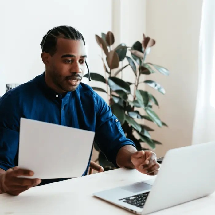 A man in a blue shirt looking at the powerful capabilities of Application Management at WordPress VIP