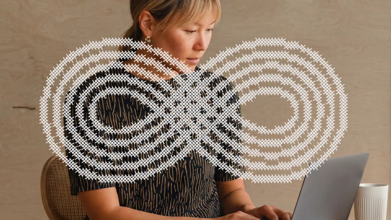 A person working on a laptop, overlaid with an infinity symbol graphic representing always on marketing campaigns vs. vendor lock-in.