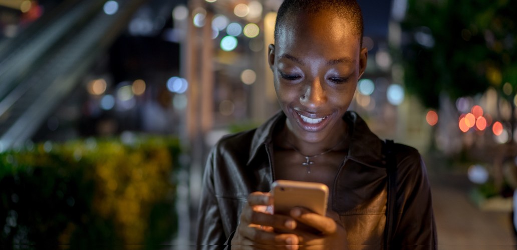 Woman engrossed in what she's reading on her smart phone.