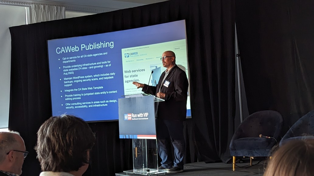 Man standing at podium, presenting on CAWeb Publishing