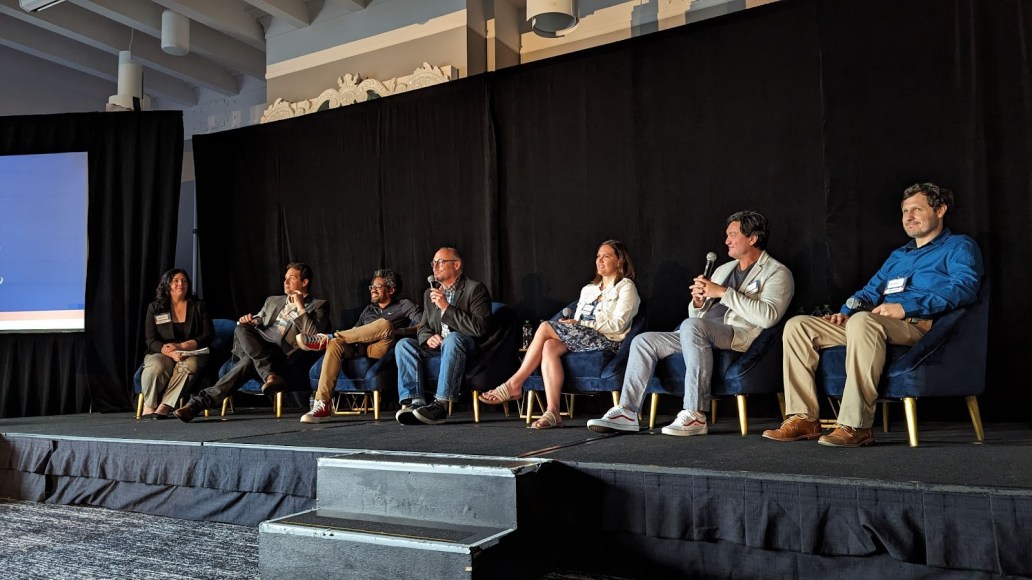 people sitting in a row on a stage