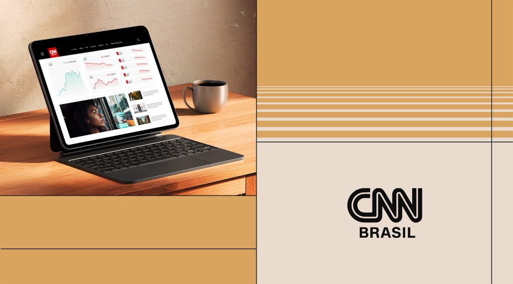 Tablet showing CNN Brasil website on a desk beside a coffee mug.